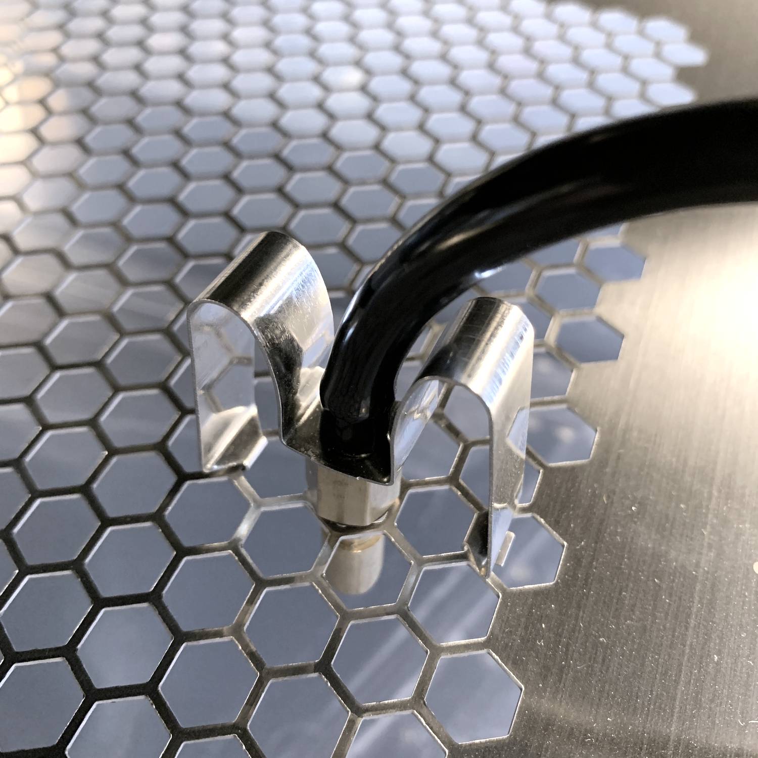 Vision Products rodent water nozzle clip in a rodent rack