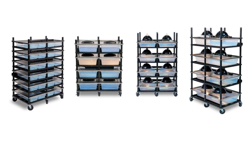 four slotted stainless steel reptile breeding versa-racks lined up on a white background
